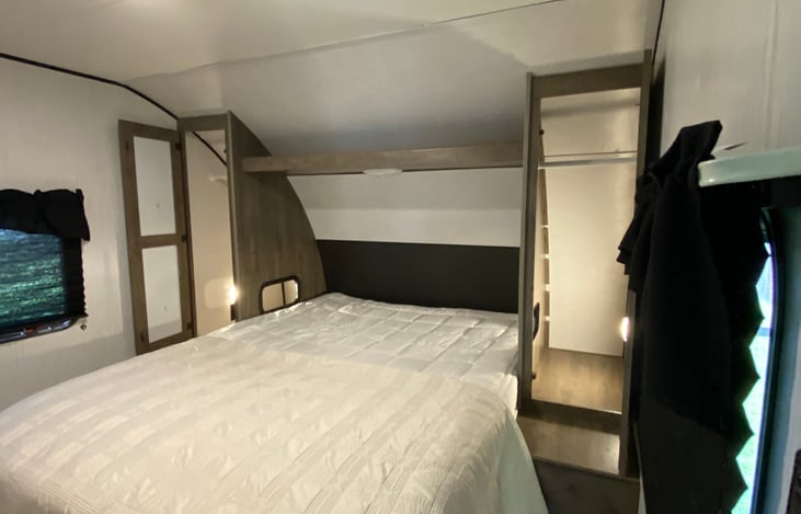 Queen size bed with extra storage underneath. Room has black-out curtains, lights and USB port on each side and reading light above.