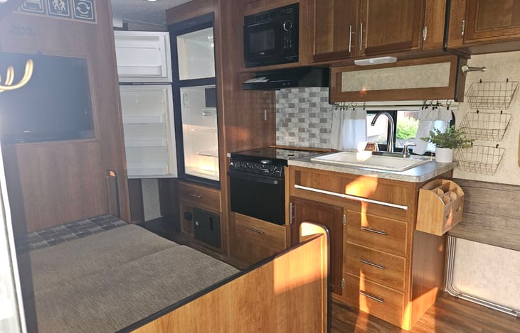 Kitchen galley table down (could be a small bed). Refrigerator and freezer open.