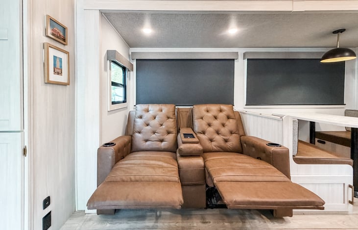 Theater seating in the living area with reclining seats.
