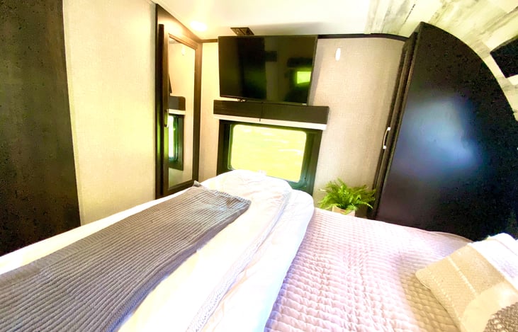 master bedroom with full king tempur pedic, television, and 3 closets for ample storage