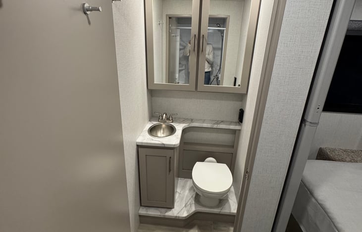 Get ready for the day in the spacious bathroom equipped with a powerful overhead fan.