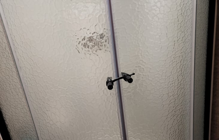 Upgraded shower with glass sliding doors.