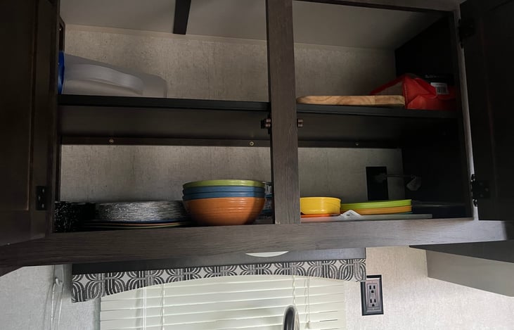 Cooking utensils and pans, plates, bowels, cups, coffee mugs, plastic wear provided.