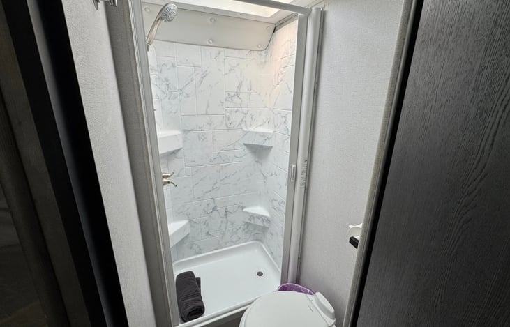 Shower and foot flush toilet.