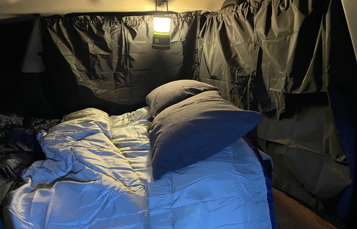 The rear cargo area provides ample room for a cozy weekend for two.  All the gear included stores behind the front seats.  The privacy curtains set up quickly and easily.