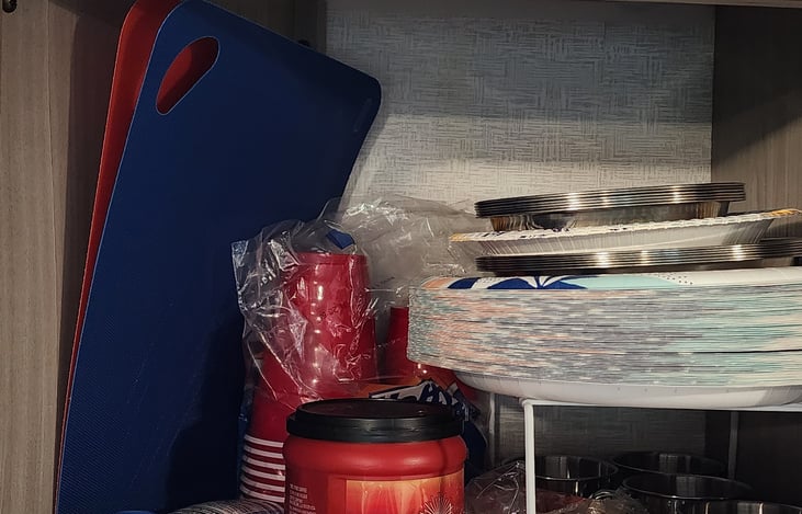 Cutting boards, paper and metal plates, bowls, cups, coffee, powder creamer.