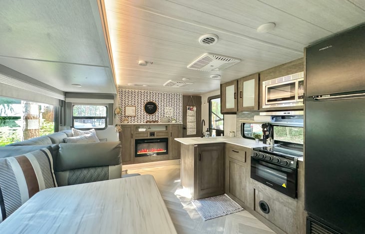 Our kitchen is fully loaded with a propane stove and cook top. Don't want to cook indoors? We have an outdoor kitchen under the awning as well