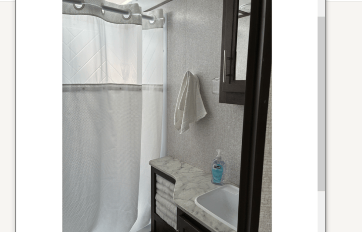 The skylight above the shower and the vent above the sink illuminate the bathroom with bright, natural light.