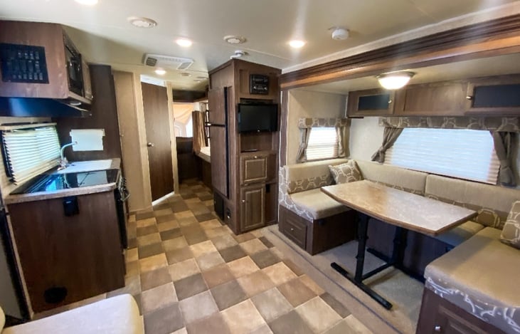 Inside looking towards back, kitchen area, bathroom, 2 back beds