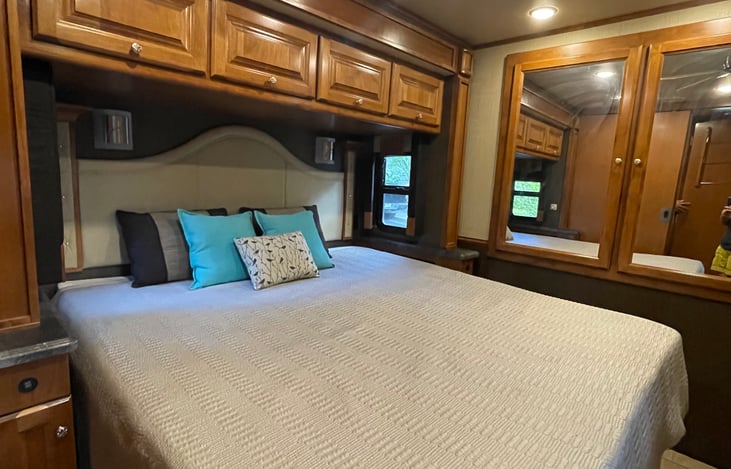 This a king-sized bed, with a mattress topper and a ceiling fan keeps it cool.