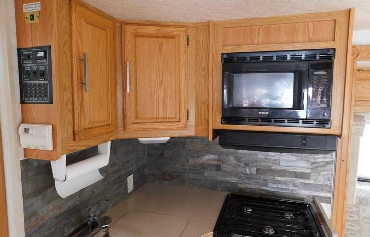 Stove, microwave, & cabinets
