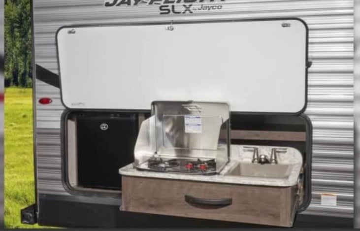 Outdoor Kitchen with sink, mini fridge and outdoor cooktop.  Must bring own propane to operate outside cooktop.