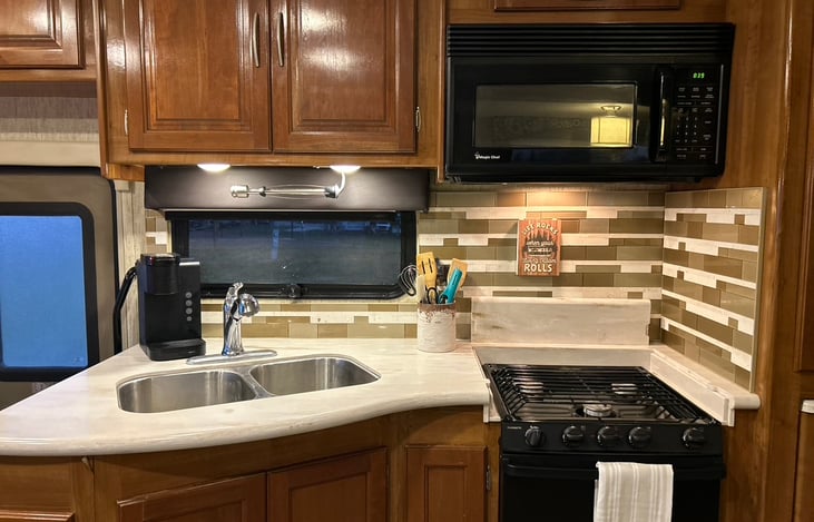 Fully equipped kitchen including double sink with sprayer.