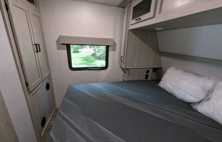 Nice bedroom with comfy King size bed, ample storage cubbies and windows for natural sunlight.