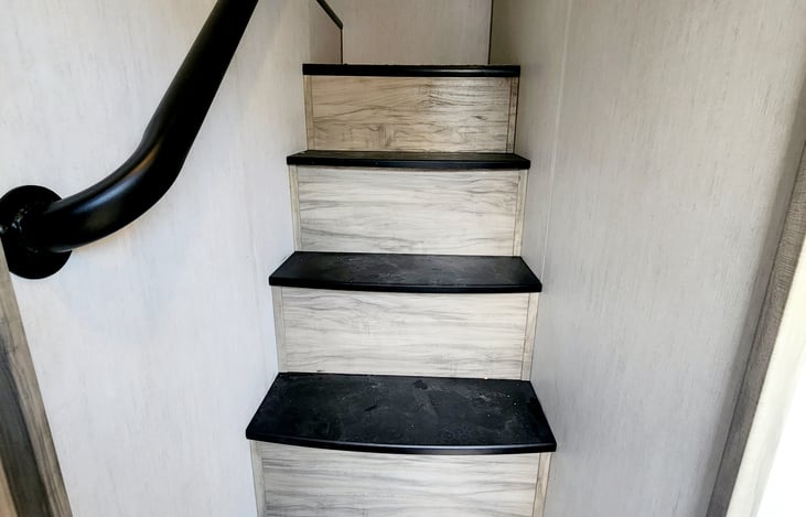 Stairs leading to loft area