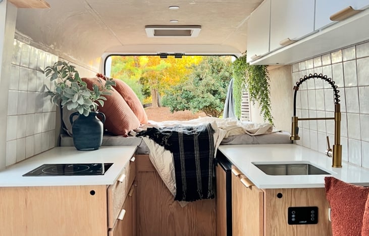 Double galley kitchen, quartz counters, induction cooktop, custom 8" foam mattress