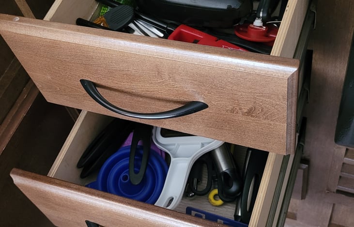 Kitchen drawers = full of eating and cooking utensils