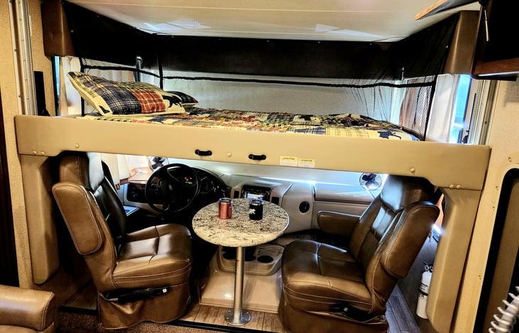 Full size bed that drops down from above the captain chairs. Great for two adults or up to three kids. 500 pound capacity.