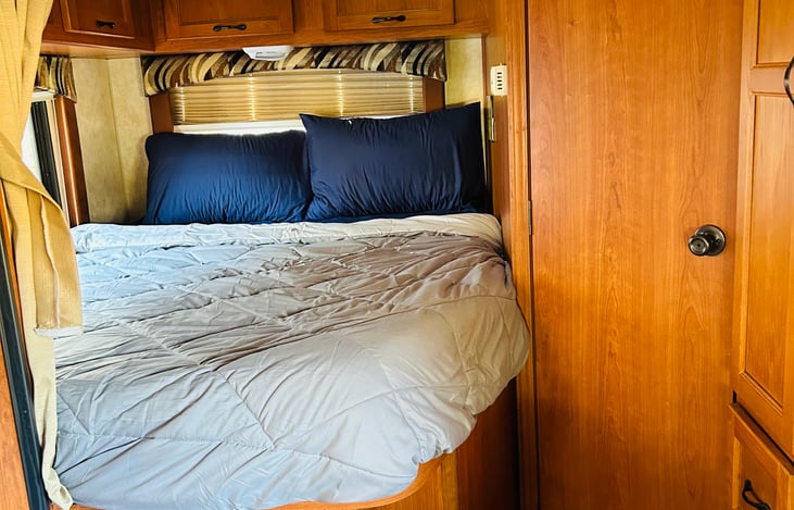 Comfortable queen bed with tv and curtain for privacy