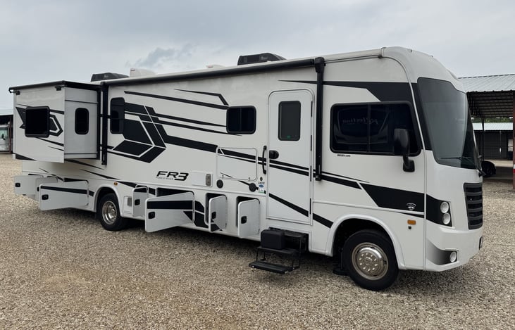 Passenger side with slide open and bays open.