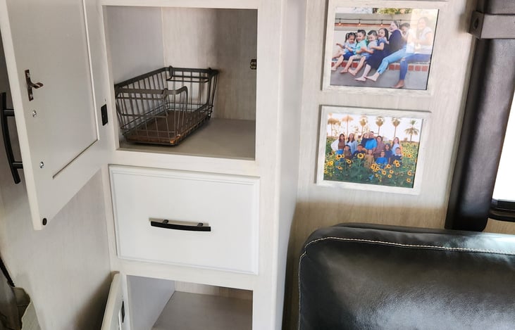 Plenty of pantry storage in between the couch and the refrigerator.
