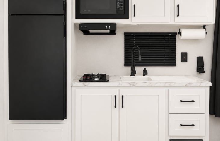 Kitchen with 2 burner propane stove, Microwave, and Large Refrigerator/Freezer.  Cooking Utensils Included.