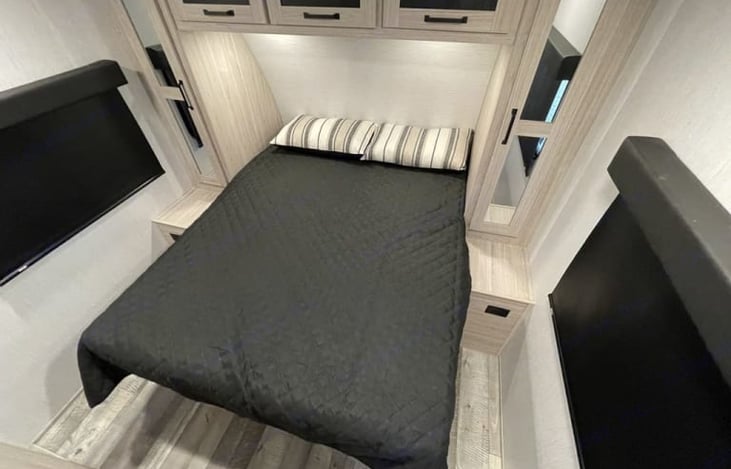 Owners Suite: Full queen sized bed, storage, tv.