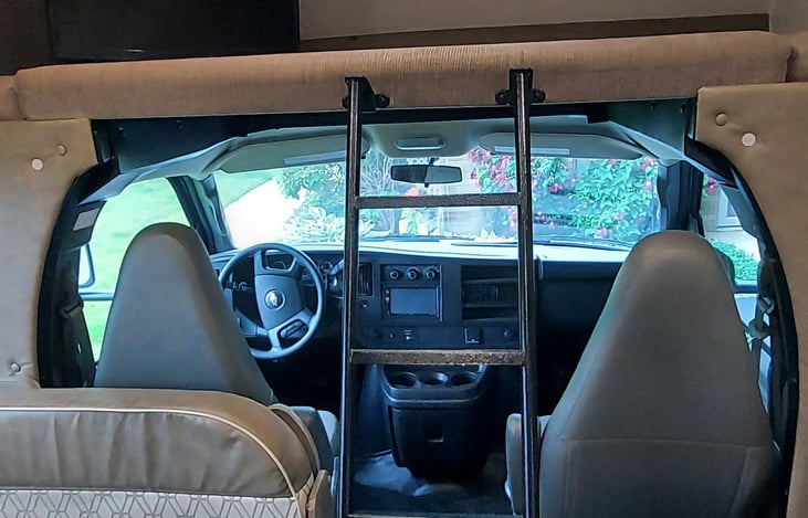 Queen bed above the cab with TV that swivels for easy viewing