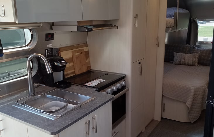 Large sink, 3 burner stove, convection oven all run by propane. Fully stocked kitchen, just bring your own meals.