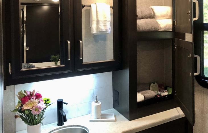 Additional storage cabinet for towels, etc. in main bathroom.