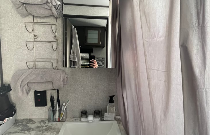 Bathroom counter.  4 bath towels, 4 hand towels, and 4 washcloths are included.  A blow dryer, toilet paper, and hand soap is also included.