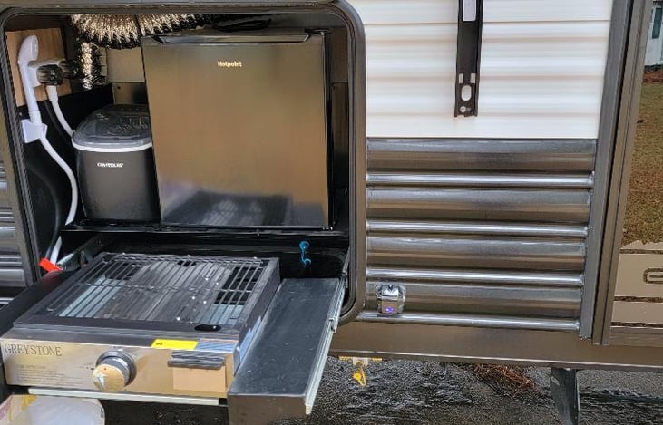 Outdoor kitchen has a grill or griddle, refrigerator to keep your beverages cool and an ice maker.  This trailer is also equipped with 2 outdoor showers.