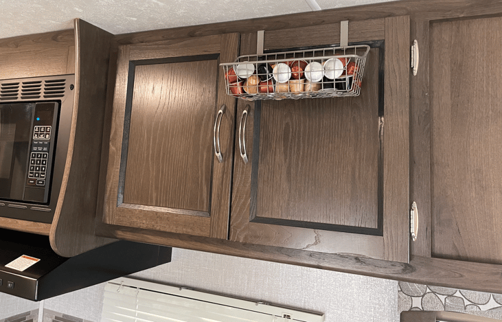 Plenty of storage - equipped with plates, cups, and more.