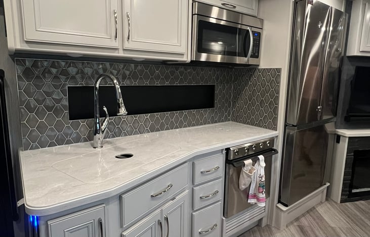 Kitchen with Full Size Refrigerator, Gas Stove and Stove Top, Convection Microwave.