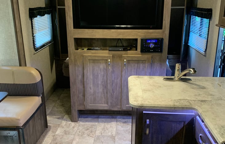 Tv with DVD player and can be turned to face master bed. Stereo has Bluetooth and all cable hook up capabilities. Three speaker setting from outside, front of trailer and back of trailer.