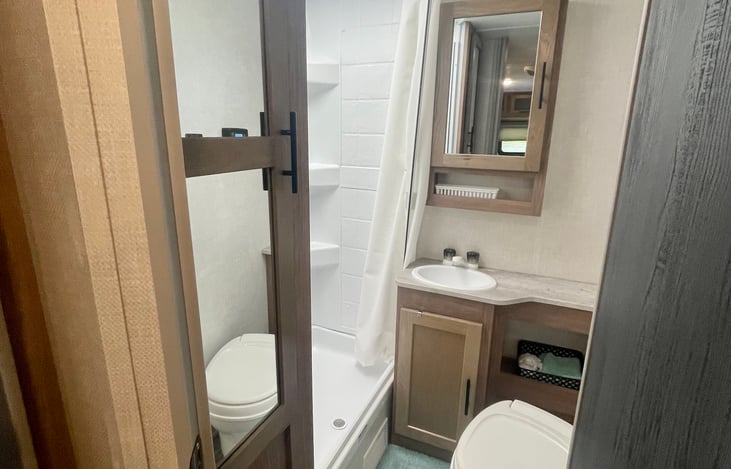 Clean and sanitized bathroom with full shower, toilet, and sink! Also with some cabinets for storage of bathroom essentials!