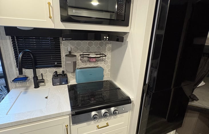3-burner stove, sink and all flatware, silverware, cooking pans, mixing bowls and cooking utensils. Not to mention an extra large refrigerator and freezer.