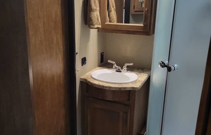 bathroom with porcelain toilet and walk in shower