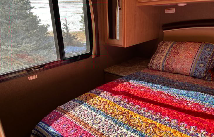 The entire RV is well-lit with screened windows including roller shades.