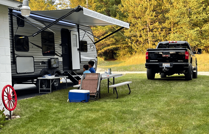 Outside speakers in awning! Folding chairs included, portable bbq , grate for fire pit for campfire cooking  fishing poles plates cups  included!