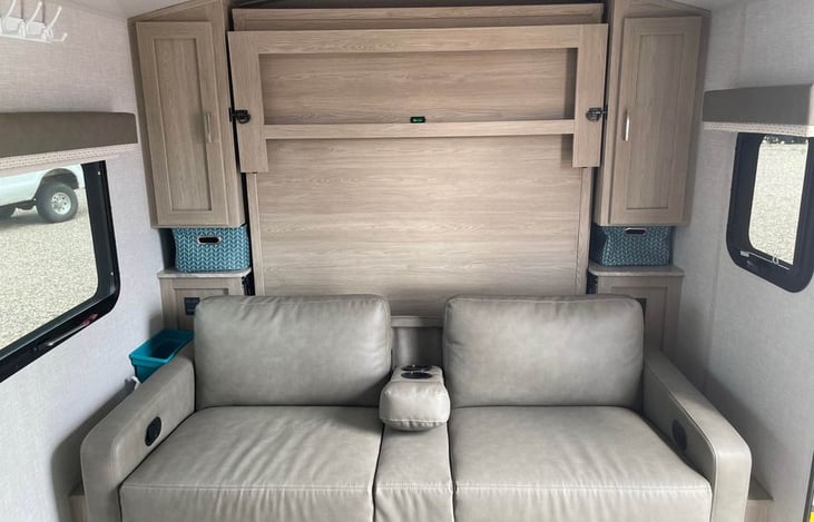 Couch with leg rests. Stowable murphy bed that allows extra space when not in use.