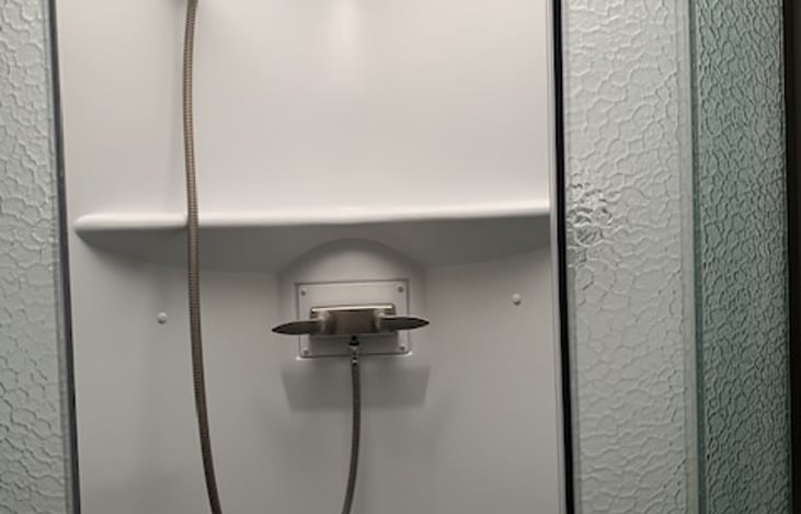 Shower will higher shelf.