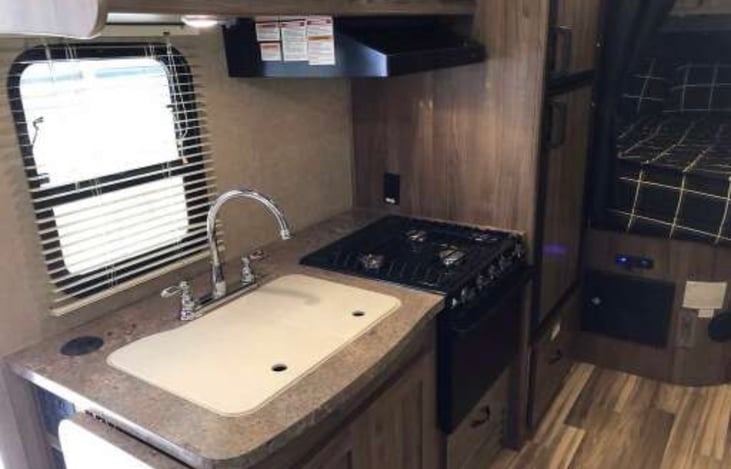 Double sink with cover provides a great working area. Propane Stove/Oven for inside cooking