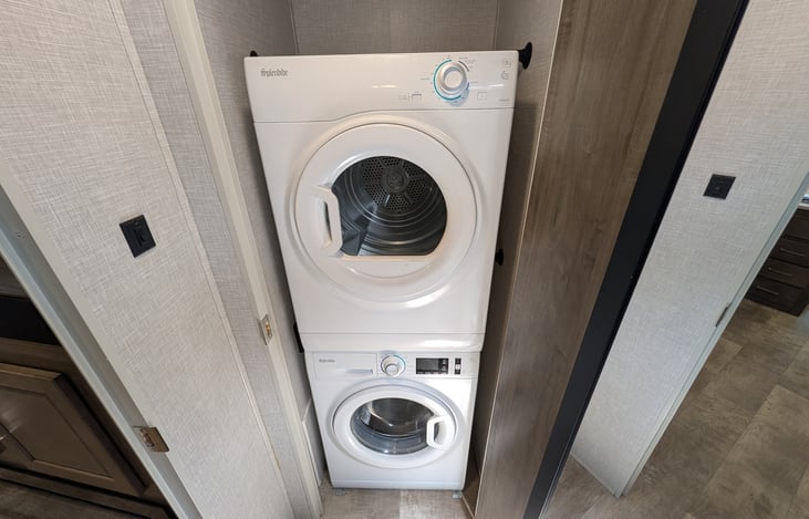 Spacious bathroom with large corner shower, glass door, and skylight for extra headroom! Includes a porcelain foot-flush toilet, medicine cabinet, vanity, and plenty of towel storage + washer/dryer.