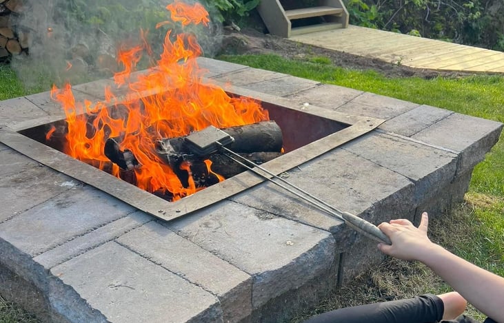 Great firepit set up with rocking metal chair (no worry about rain), cooking tools, and best of all... free wood!