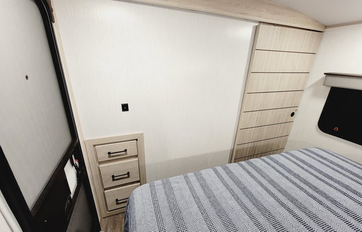 Additional drawers for storage in bedroom and a sliding door for privacy.