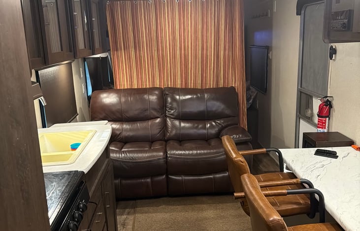 Plush leather rocker recliner love seat.