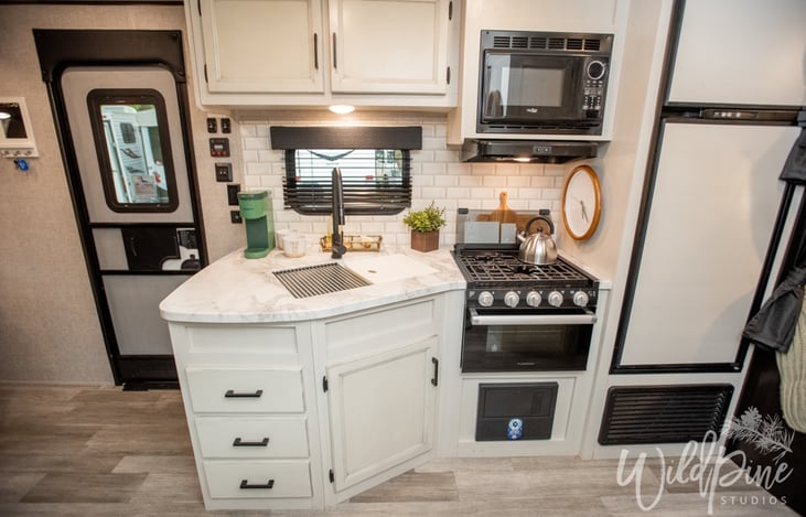 Kitchen Equipped With Stovetop, Oven, Microwave, Refrigerator and Freezer