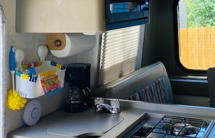 There is a microwave, 2 burner gas stove, small sink and refrigerator as well.