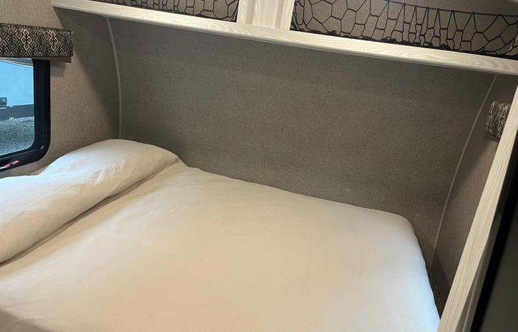 Comfortable Queen size bed with mattress cover.storage above.